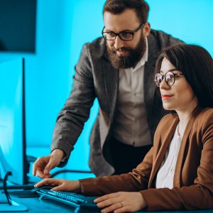 5 dicas de como dar feedback corretamente | dois parceiros de negócios trabalhando juntos no escritório no computador